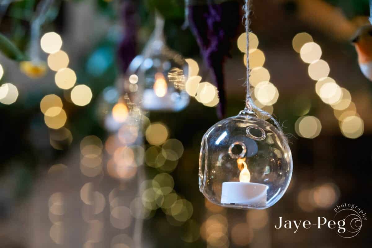 a candle in a glass sphere hanging from the ceiling