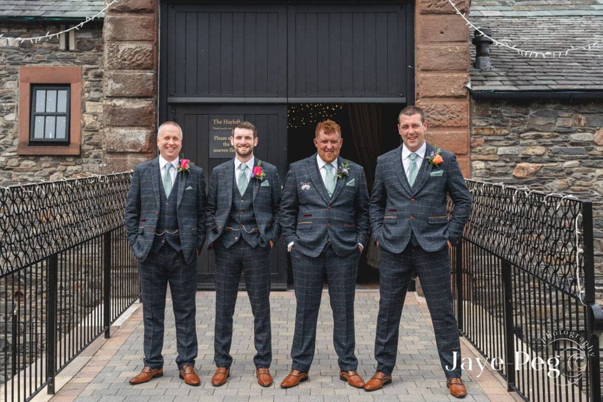 a grooms party outside the hayloft at new house farm