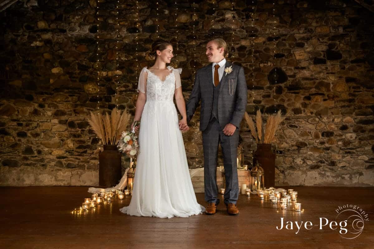 a bride and groom in the loveable old barn at low hall the lakes in the lake district