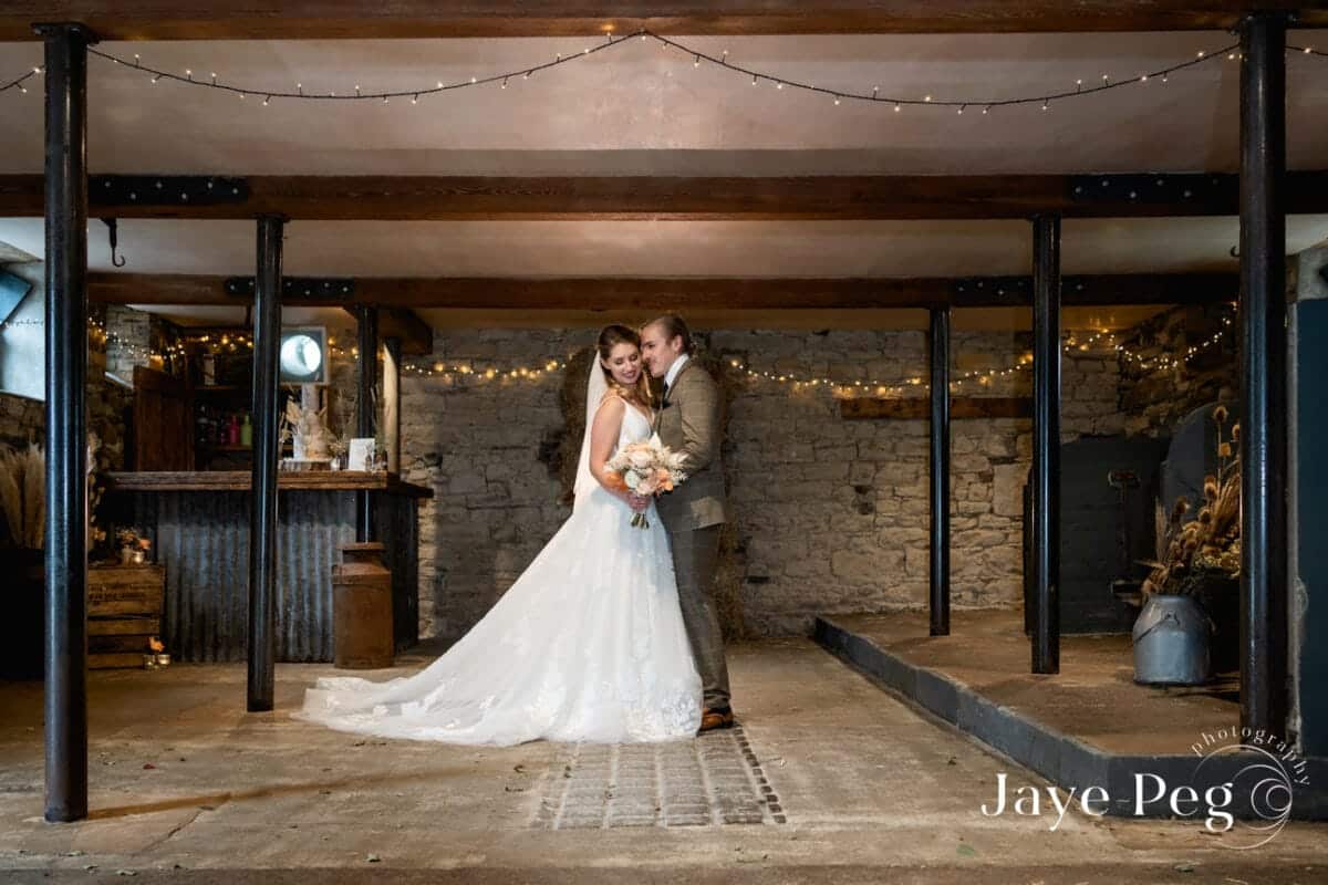 a bride and groom in the loveable old barn at low hall the lakes in the lake district