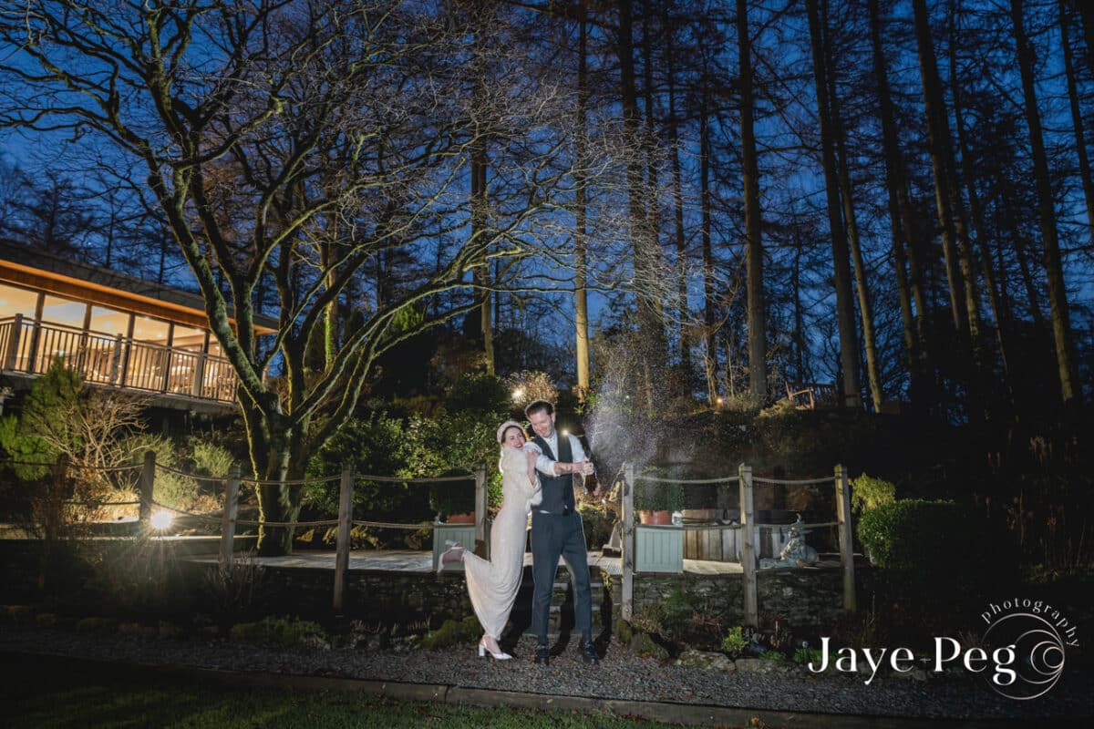 a bride and groom celebrating with champagne after their wedding at gilpin lake house