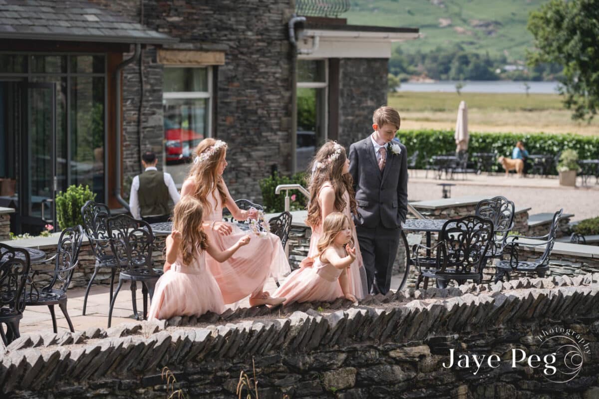 Bridal party outdoors at countryside wedding venue.