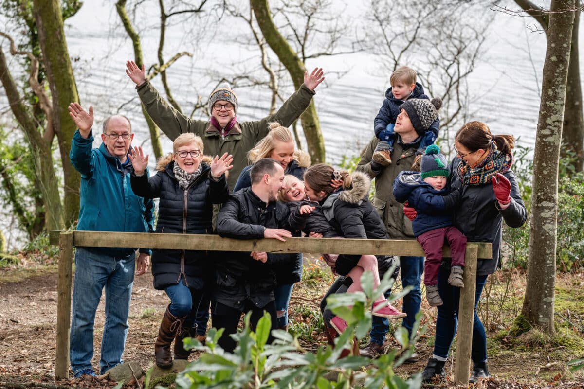 a family group laughing and joking around by derwentwater