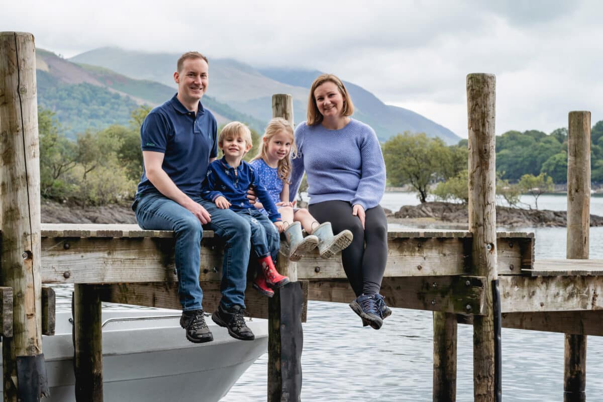 a family photographed on a lake district jetty