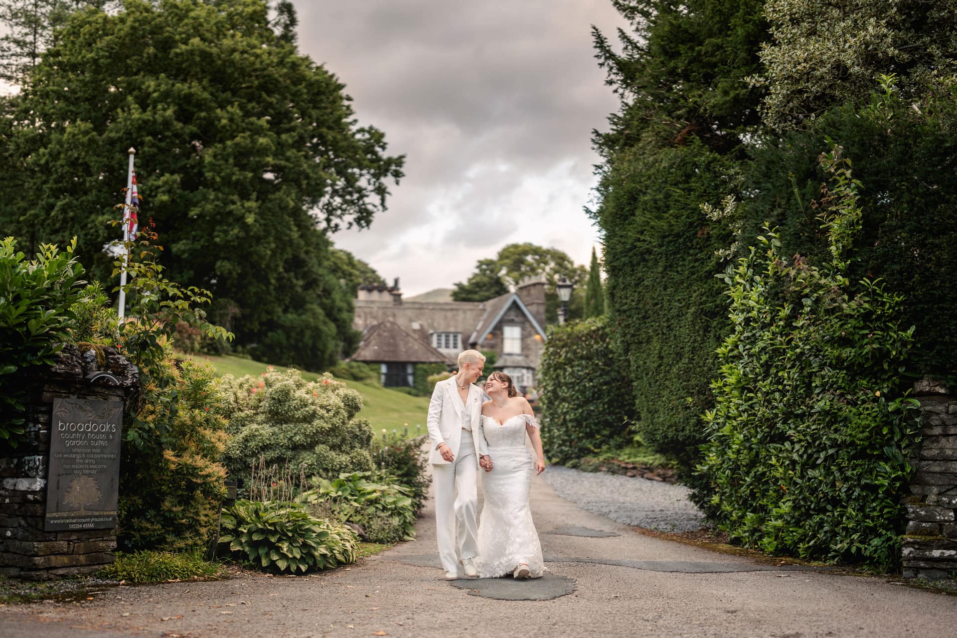 two brides walking down the driveway at Broadoaks Country House Hotel in the lake district
