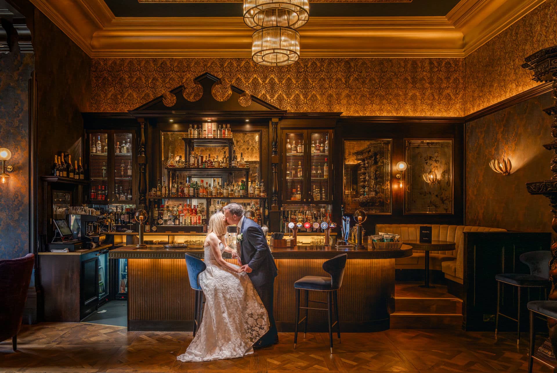 a bride and groom embrace in a luxury bar