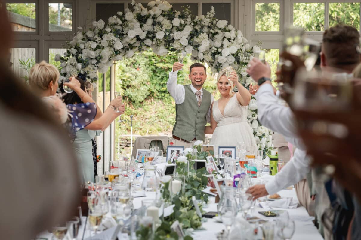 - Ben and Leanne toasting with guests at their Broadoaks Country House wedding