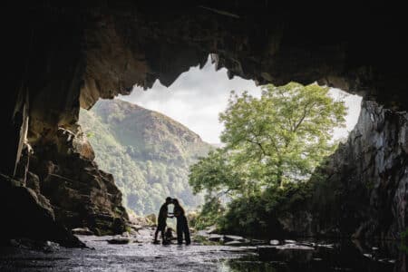 a couple kissing in rydal cave in the lake district